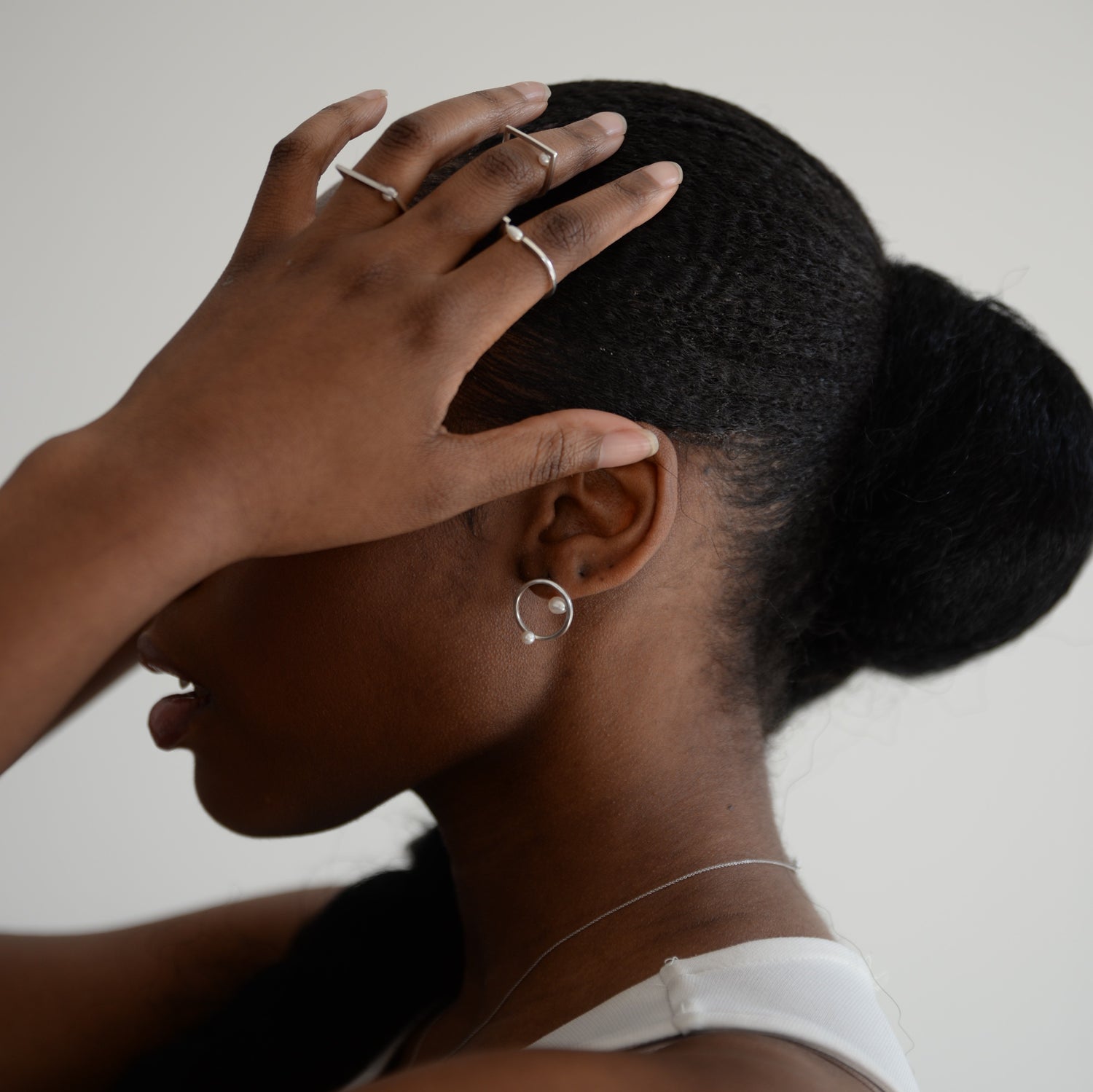 Model Wearing Silver Earrings: A person showcasing the elegant silver earrings, demonstrating their modern sophistication and perfect fit for everyday wear.