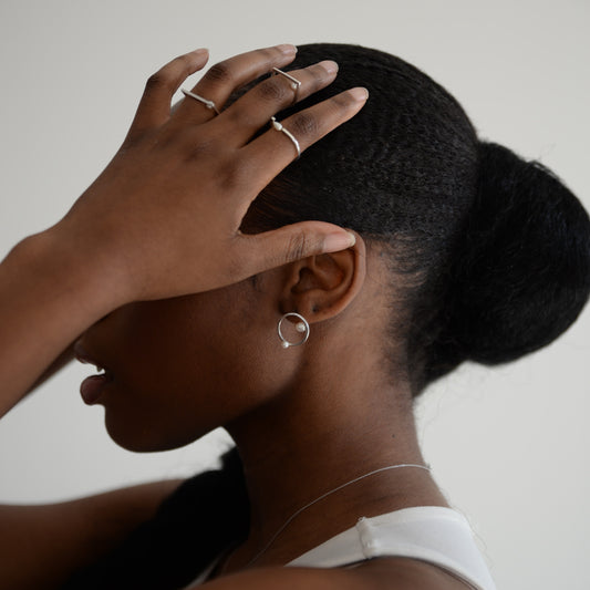 Model Wearing Silver Earrings: A person showcasing the elegant silver earrings, demonstrating their modern sophistication and perfect fit for everyday wear.