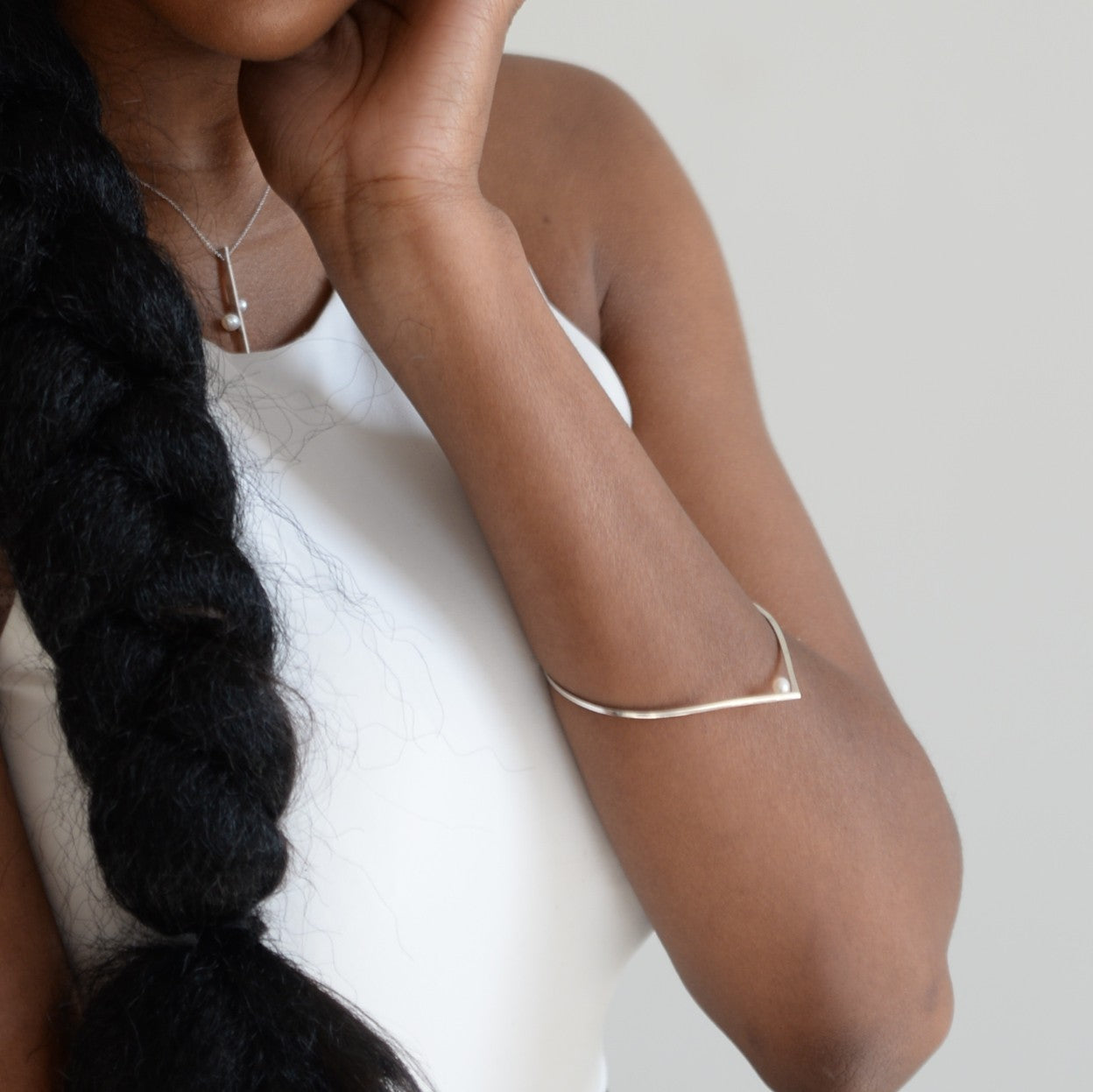 A woman showcasing the elegant bangle bracelet, demonstrating its minimalist sophistication and perfect fit for everyday wear.