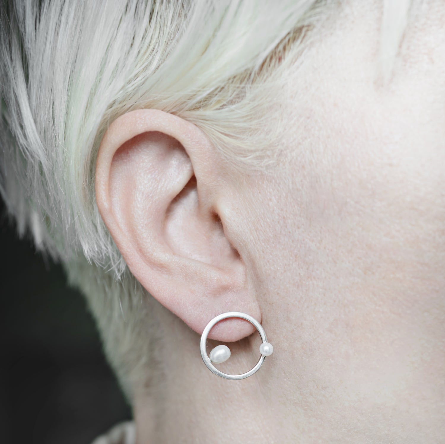 Model Wearing Silver Earrings: A person showcasing the elegant silver earrings, demonstrating their modern sophistication and perfect fit for everyday wear.